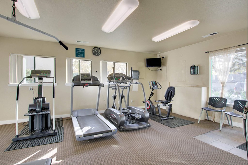 A gym with treadmills, elliptical machines, and other exercise equipment at Aspenridge Apartments, Vancouver, WA 98683