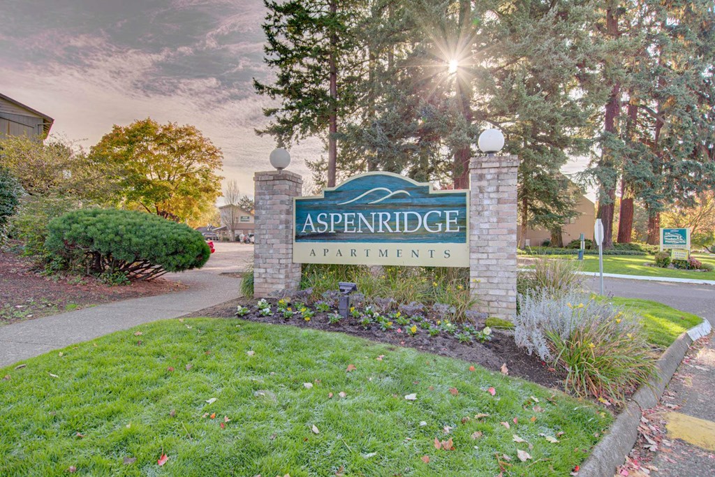 A sign that says Aspenridge Apartments in front of a building at Aspenridge Apartments,Washington 98683