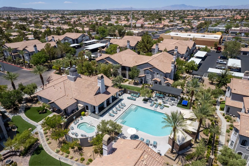 A large house with a pool in the middle of a neighborhood.