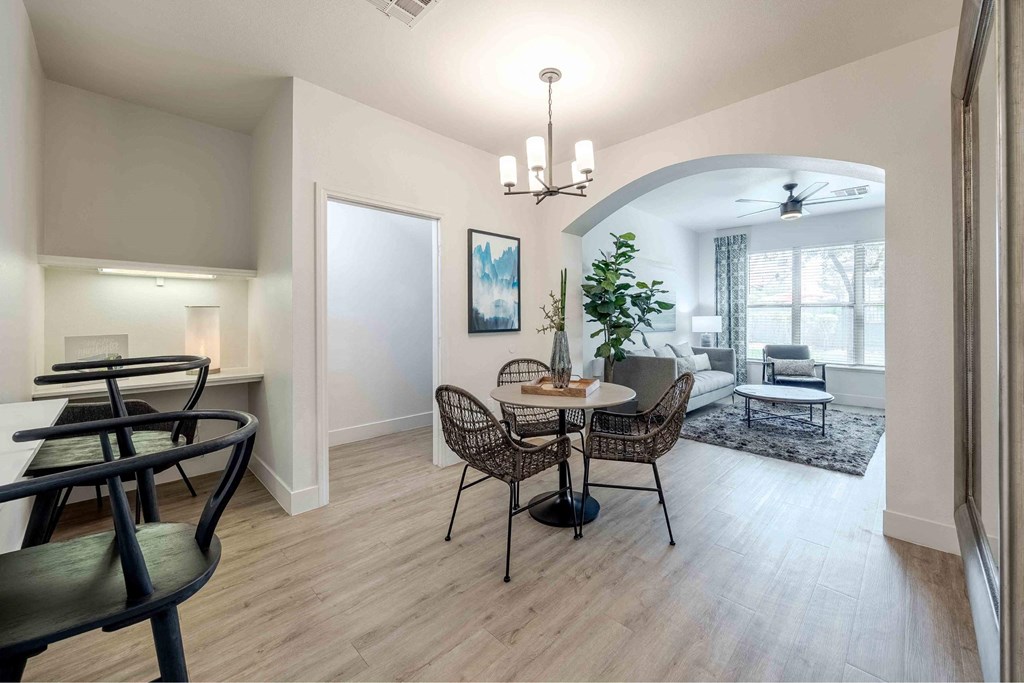A living room with a black chair and a table.