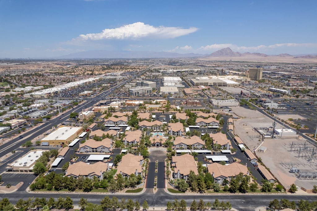 A large, open area with a few buildings and a mountain in the distance.