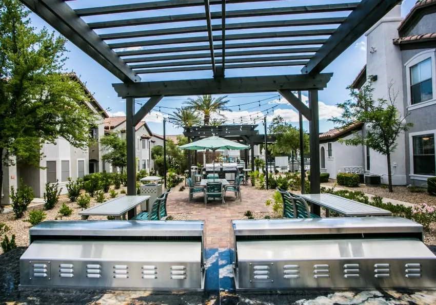 A patio with a table and chairs under a roof.