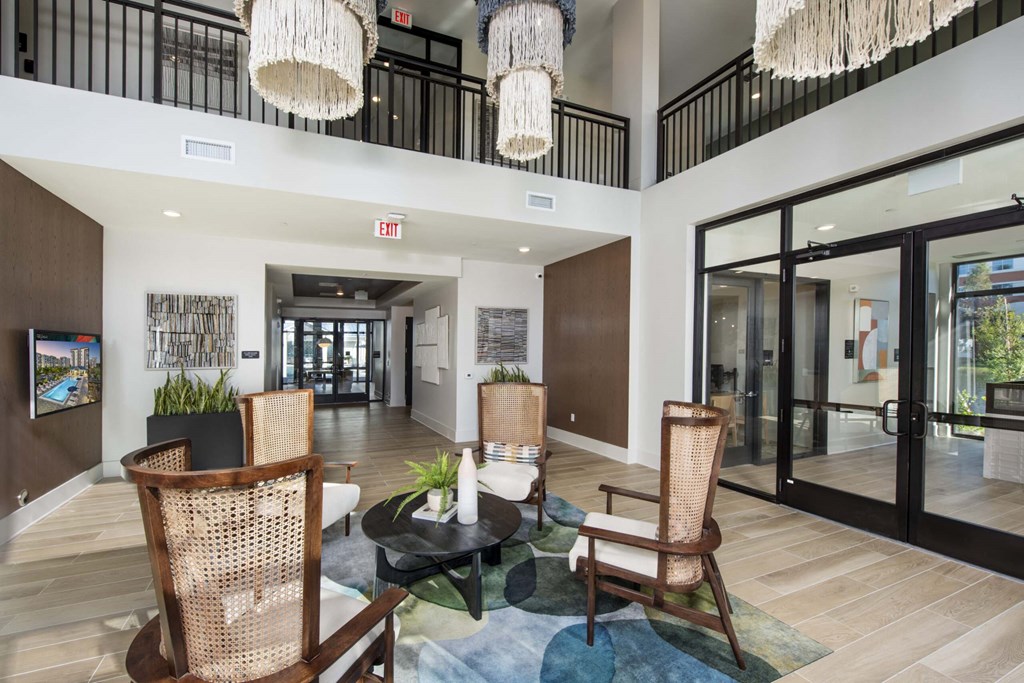 A large room with a glass table and chairs.