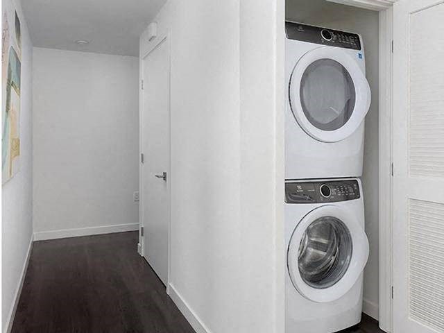 A white washing machine is in a small room.