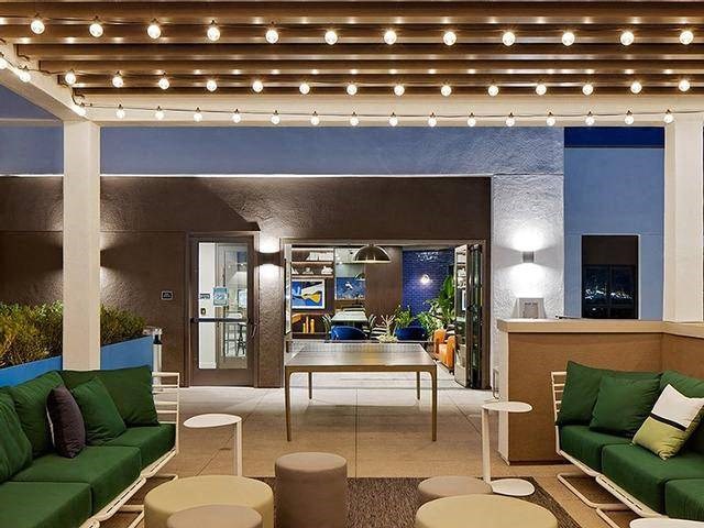 A patio area with a table, chairs, and a bar.