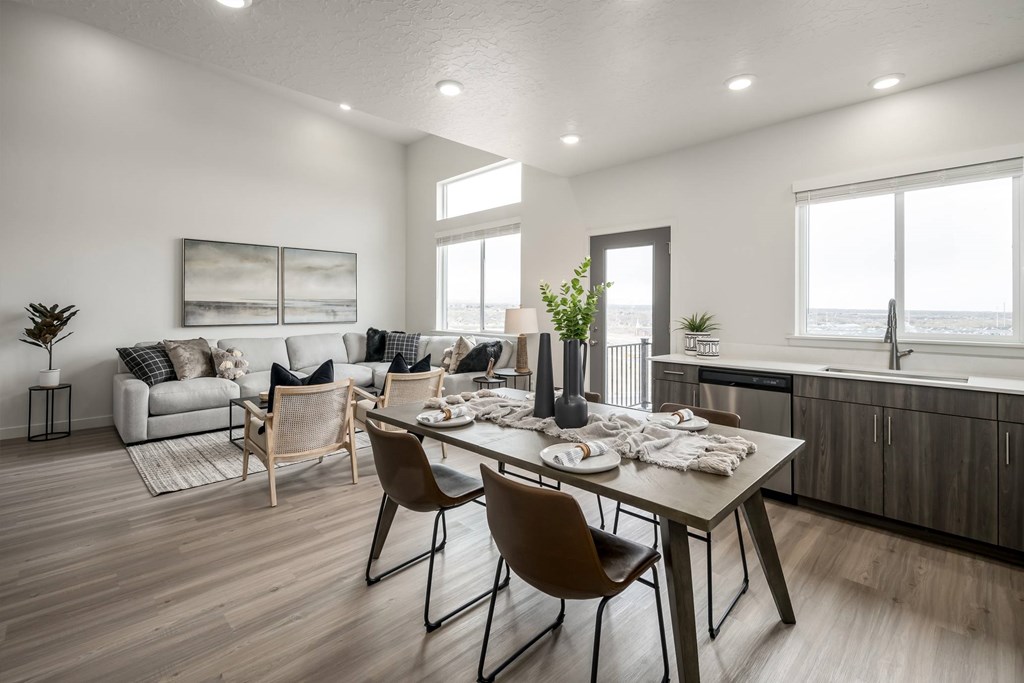 A modern dining room with a wooden table and chairs.