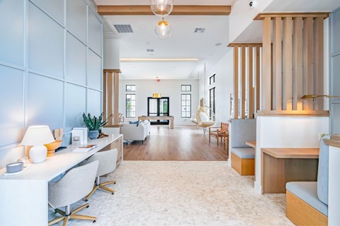 A modern office space with white furniture and wooden accents.