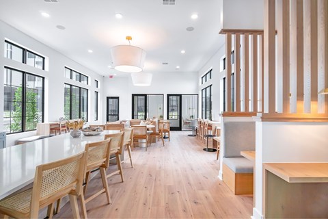 A modern dining room with wooden chairs and tables.
