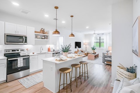 A modern kitchen with white cabinets and a center island.