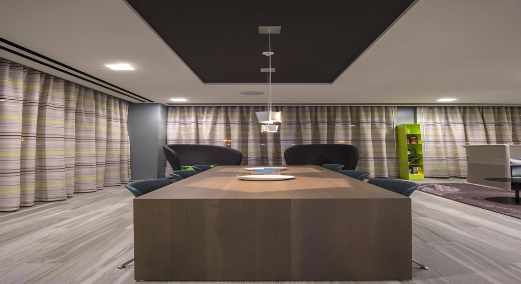 A conference room with a long table and chairs.