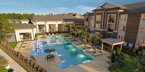 A large outdoor swimming pool surrounded by lounge chairs and umbrellas.