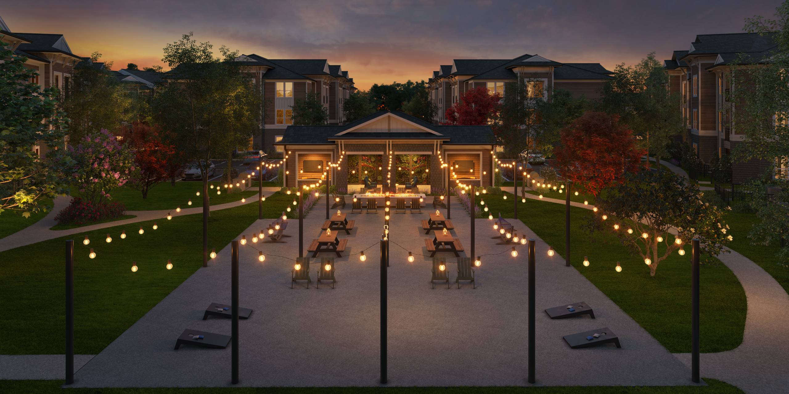 A pathway with lights and benches leading to a building.