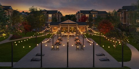 A pathway with lights and benches leading to a building.