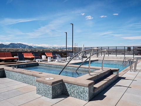 Roofdeck with pool, cabanas and spa with mountain views
