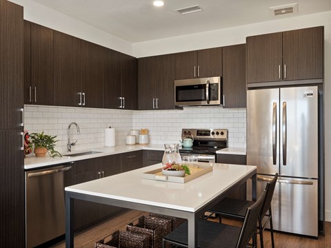 a kitchen with stainless steel appliances and a white counter top