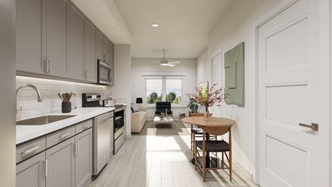 A modern kitchen with a dining table set for two.