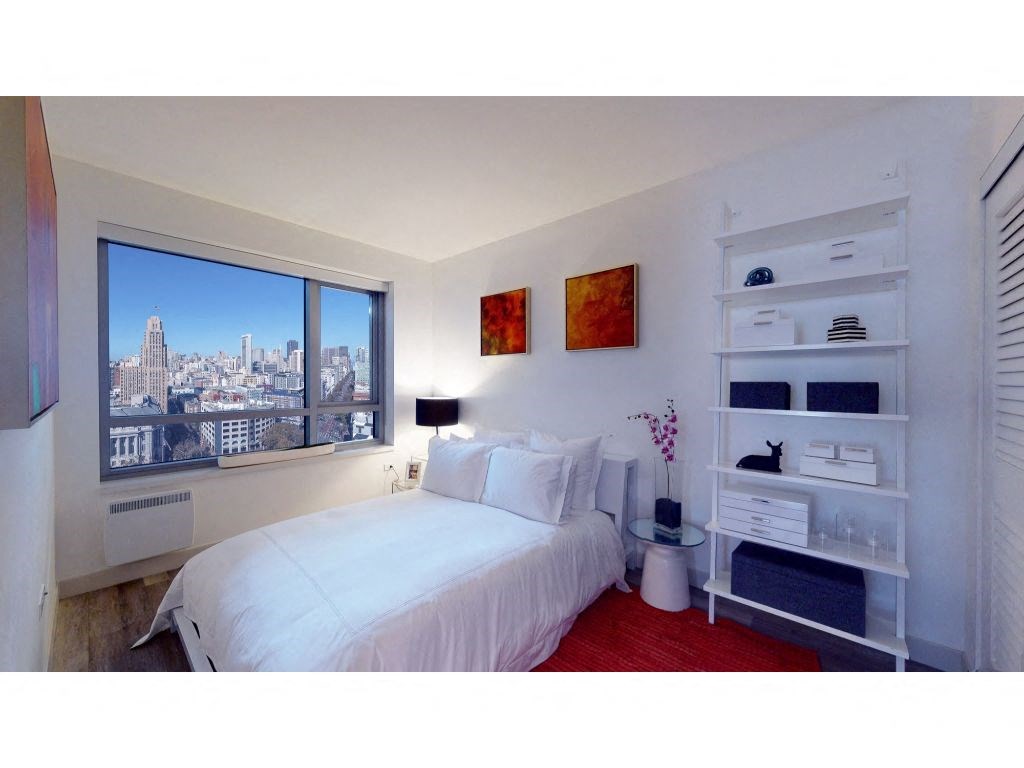 a bedroom with a bed and a window