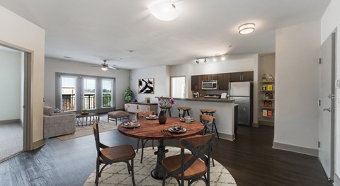 A modern dining room with a wooden table and chairs.
