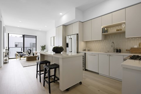 A modern kitchen with white cabinets and a large island.