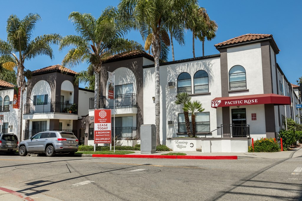 a building with palm trees in front of it on a street at Pacific Rose, Los Angeles, CA 90034