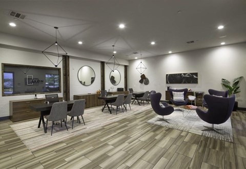 A modern living room with a grey sofa set and a wooden floor.