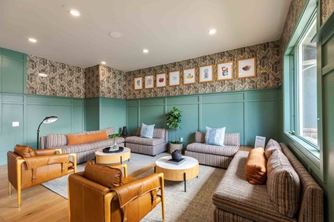 A living room with a brown leather chair and a round coffee table.