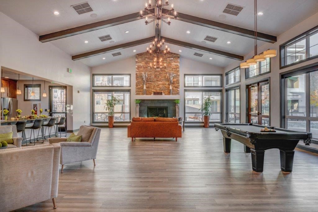 Large clubhouse with vaulted ceilings, pool table, sitting area, and fireplace