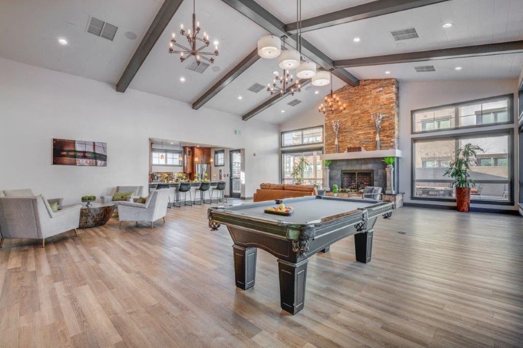 Large clubhouse with vaulted ceilings, pool table, sitting area, and fireplace