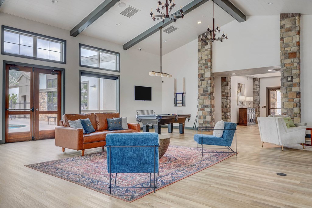 A living room with a blue chair in the middle of the room.