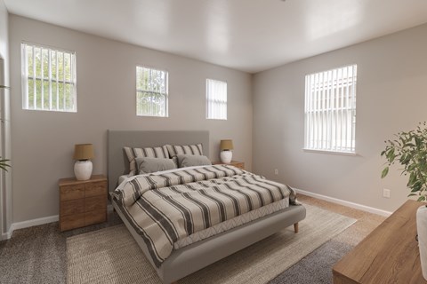 A bedroom with a large bed and two windows.