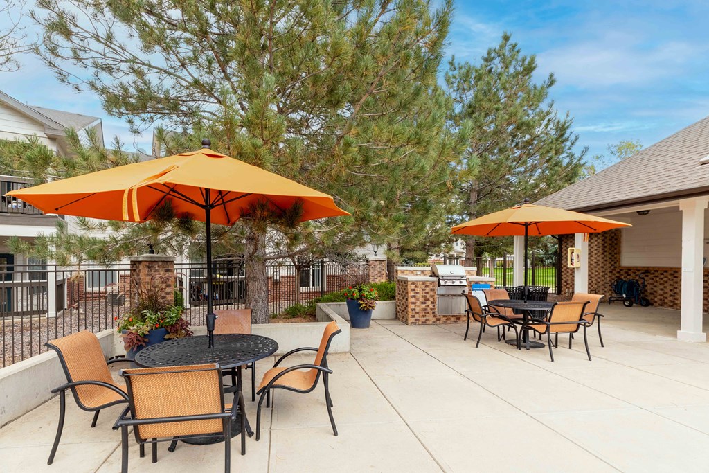 a patio with tables and chairs and umbrellas