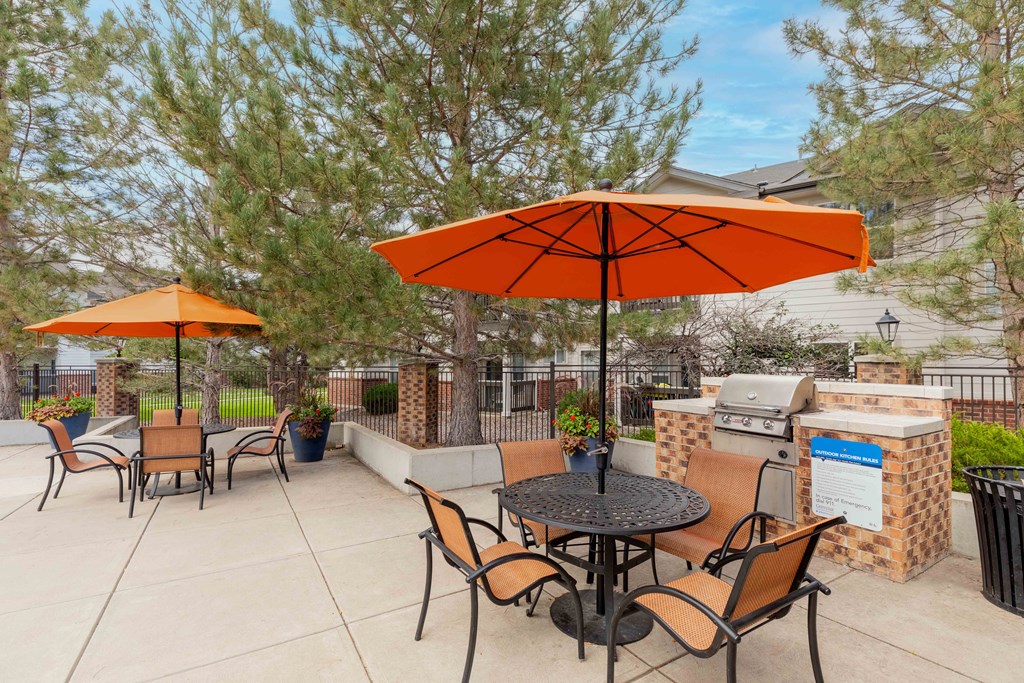 our patio has an umbrella and tables with chairs and umbrellas