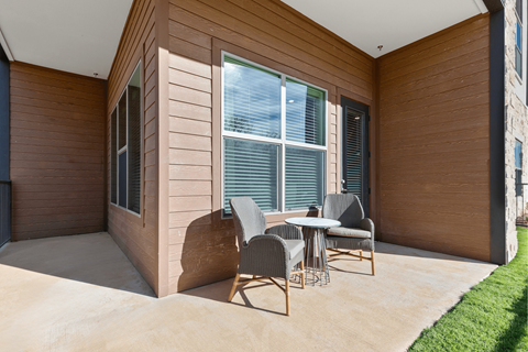 A patio with a table and chairs