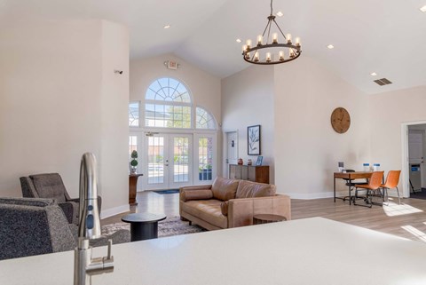 clubhouse with a couch, chairs, and a dining table.