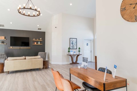 clubhouse with a grey couch and a wooden table.