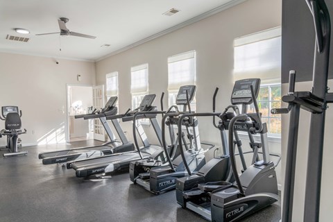 A gym with treadmills and elliptical machines.