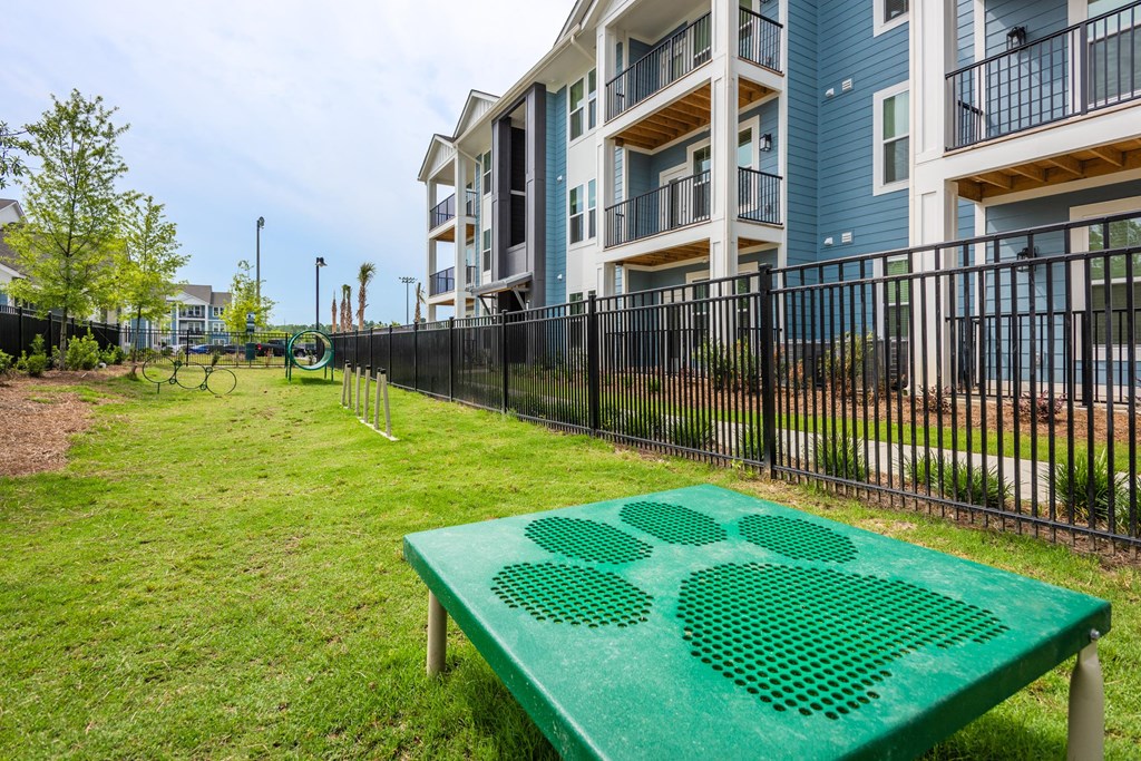 a green ping pong table in front of an apartment building