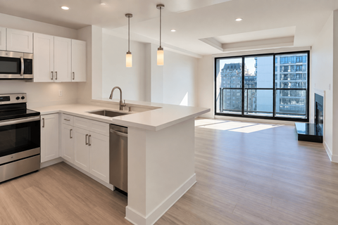 A modern kitchen with white cabinets and a large island.
