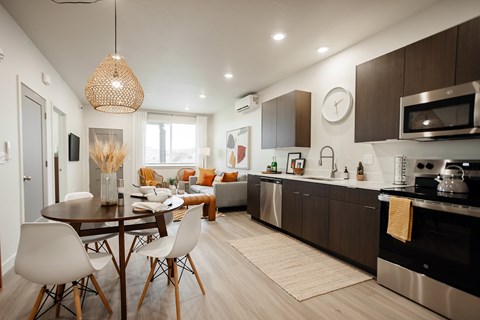 A modern kitchen with a dining table and chairs.