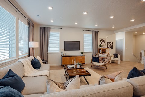 A living room with a white couch and a wooden coffee table.