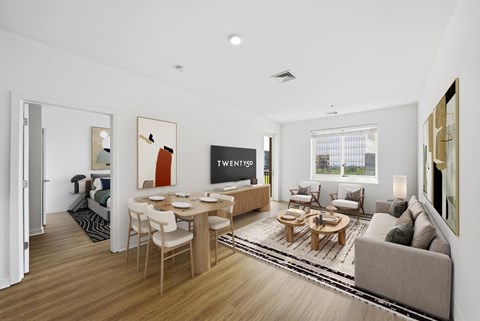 A modern living room with a dining table and a couch.