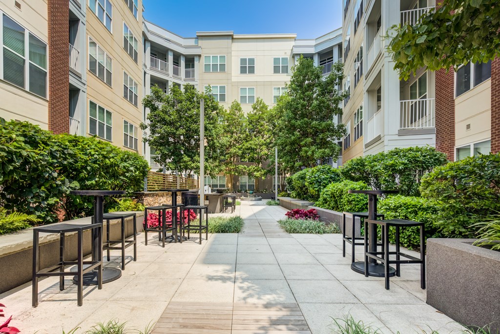 an outdoor patio with tables and chairs