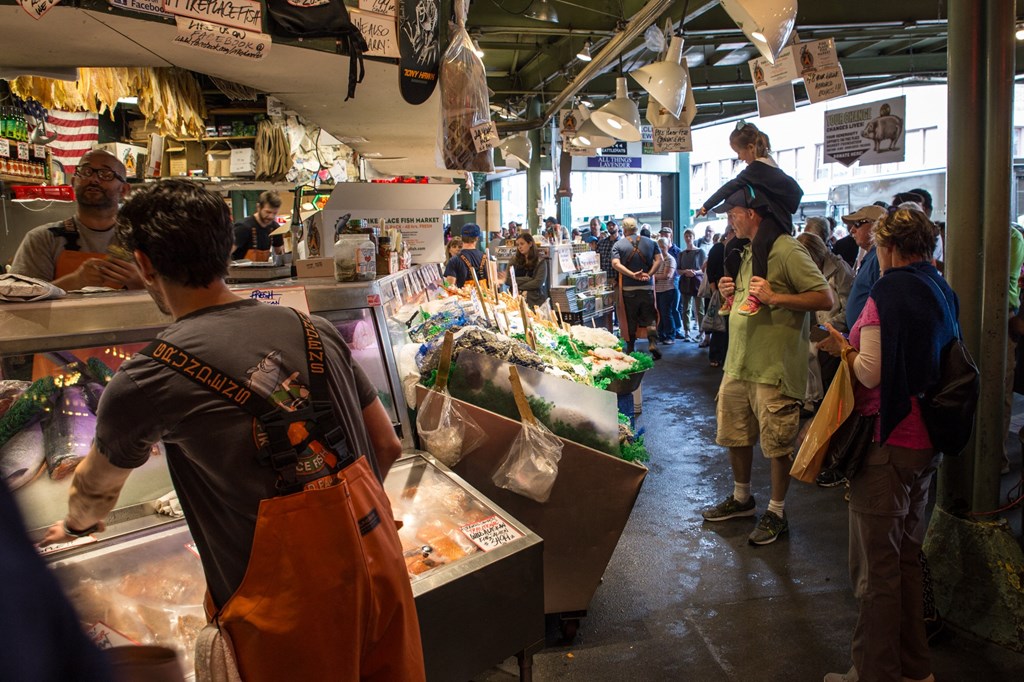 people standing in line at a fish market