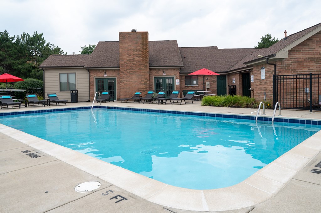 a swimming pool with a brick building in the background