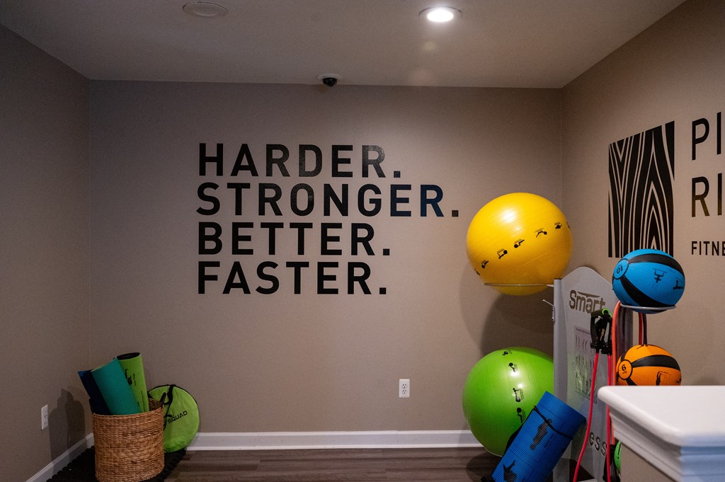 a quote on a wall in a room with balloons and other toys