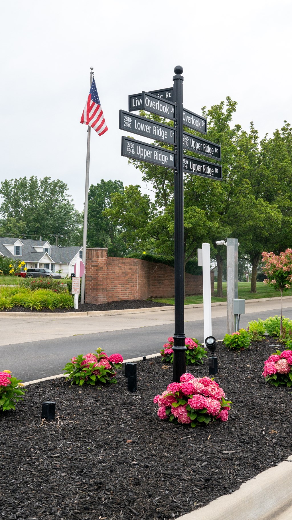 a street sign in front of a building with a flag on a pole