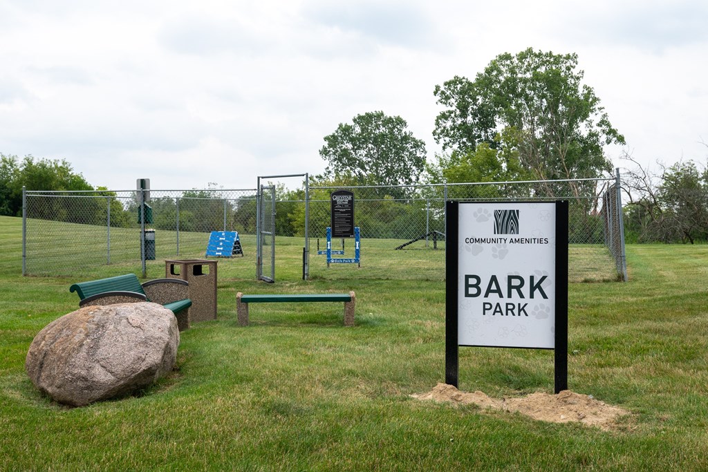 a park with a sign that says bark park