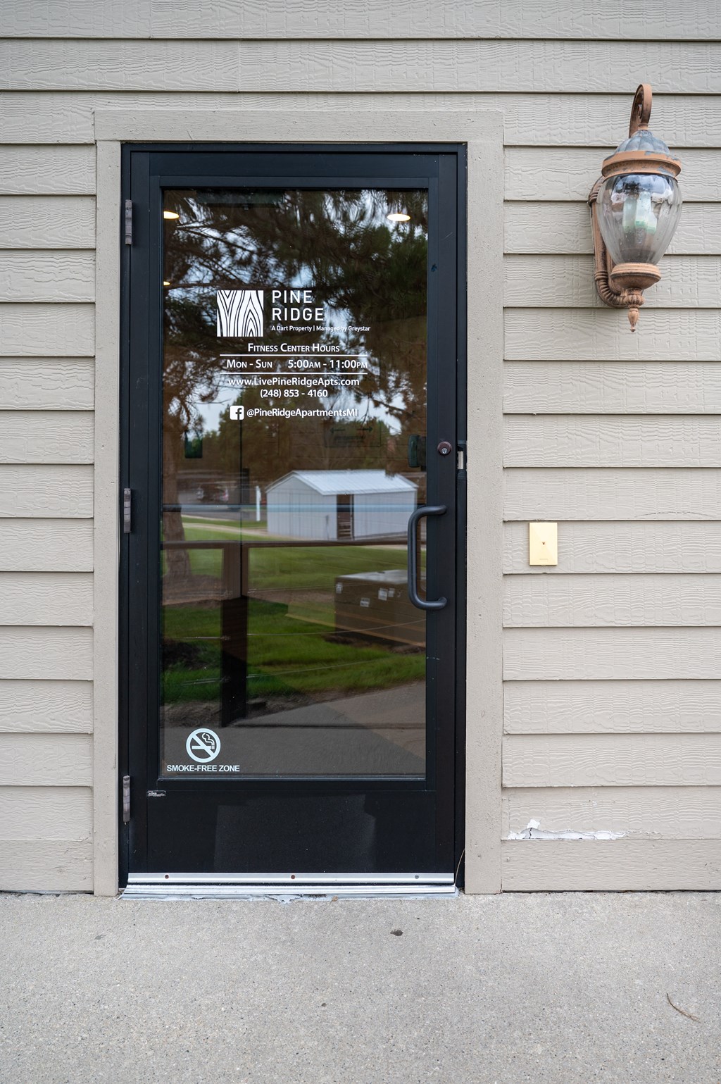 a black door with a white sign on it