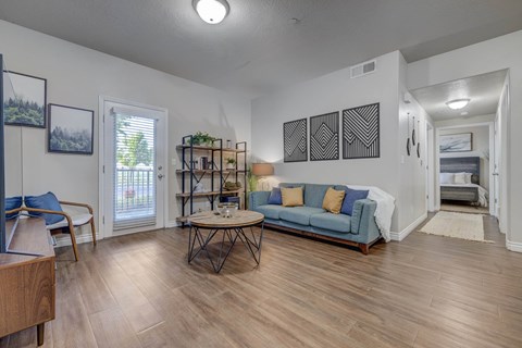 A living room with a blue couch and a wooden coffee table.