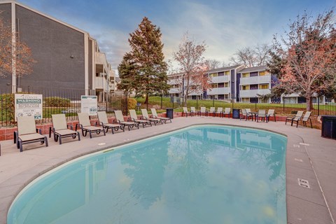 Outdoor swimming pool and sundeck with lounge seating at The Pointe at Northridge apartments in North Salt Lake, UT